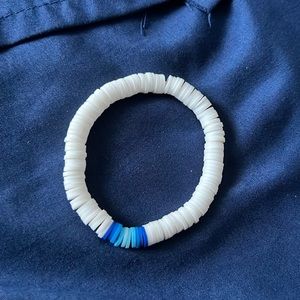 Youth clay bead bracelet with stretchy clear string.